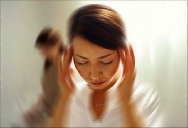 Woman in distress from vertigo needing physiotherapy for vestibular rehabilitation at Cross Roads Physiotherapy & Massage Therapy in Vancouver