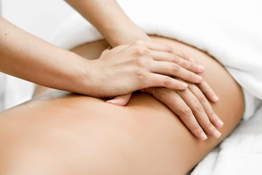 Patient receiving massage treatment to her low back at Vancouver massage therapy clinic Cross Roads Physiotherapy & Massage Therapy
